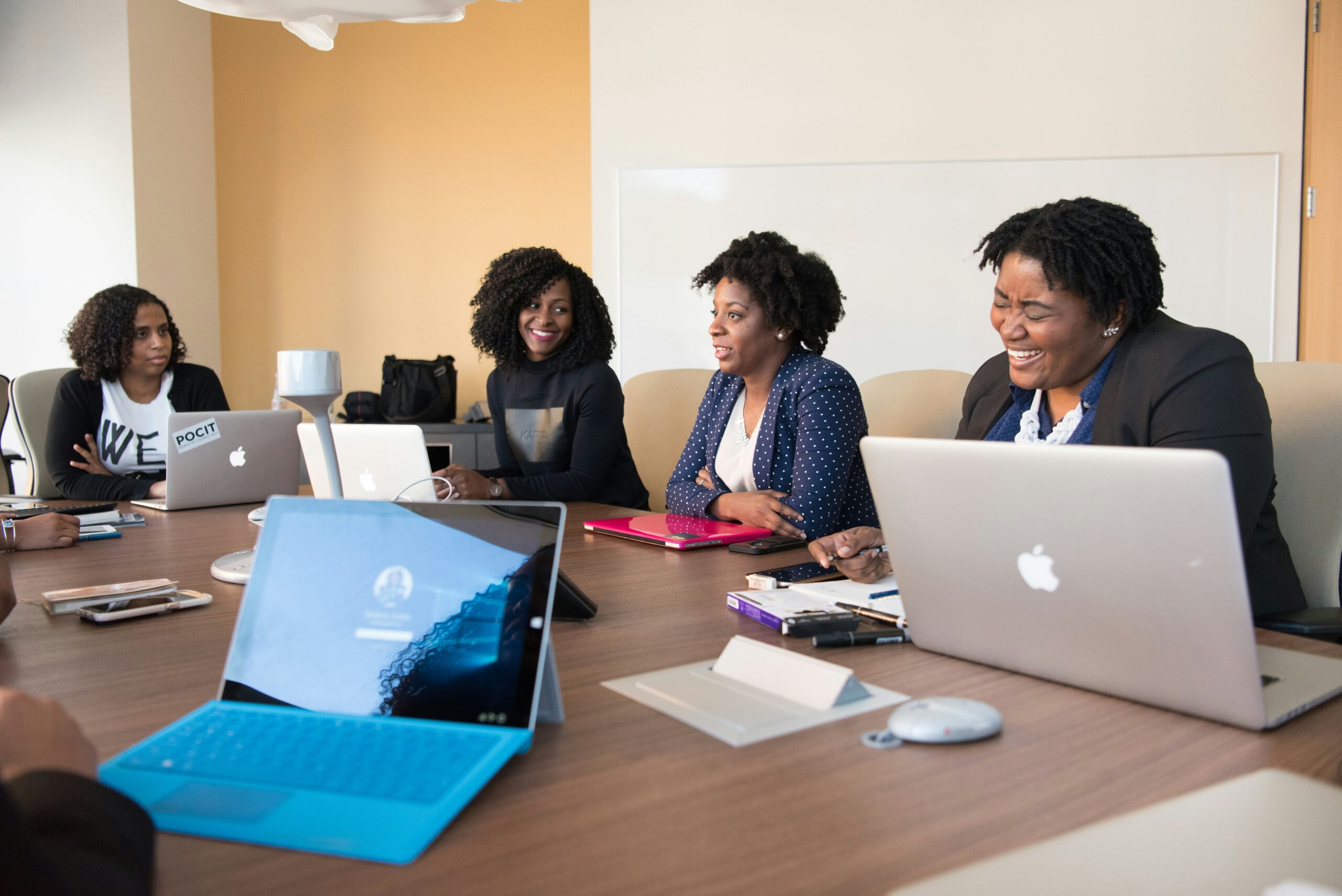 Women having a collaborative meeting in a professional office setting.